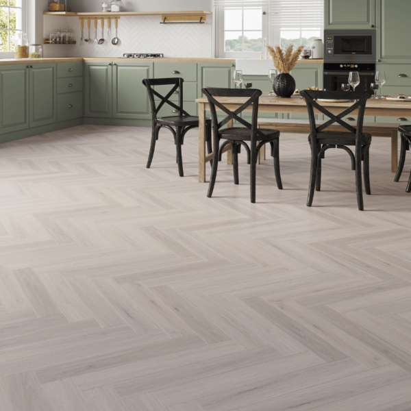 Wide room view of Devon LVT Herringbone Light Grey Oak flooring with herringbone design and micro-beveled edges