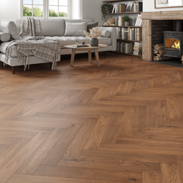 Wide room view of Dorset Herringbone Laminate Golden Brown Oak flooring with warm tones and a herringbone pattern