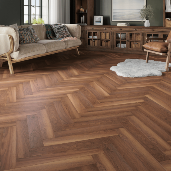 Wide room view of Dorset Herringbone Laminate Walnut & Caramel Oak flooring with warm dual tones and bevelled edges