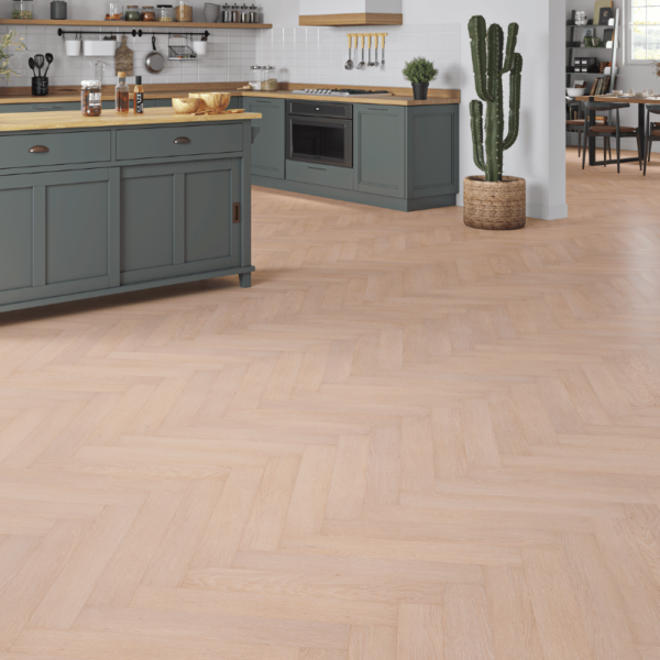 Wide room view of Dorset Herringbone Laminate White Washed Oak flooring with soft, white-washed tones and bevelled edges.