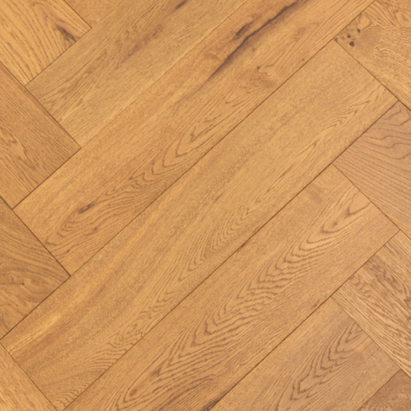 Aerial view of Hardwick Herringbone Engineered Oak flooring showcasing intricate herringbone pattern and golden brushed UV oiled finish