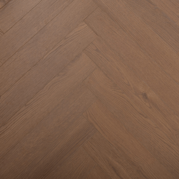 Aerial close-up of Prestige Herringbone 12mm Chocolate Oak laminate flooring plank, featuring dark wood grain and V-groove edges