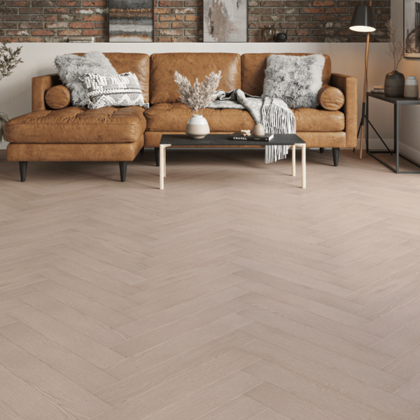 Prestige Herringbone 12mm Light Grey Oak laminate flooring in a modern room with herringbone design and bevelled edges