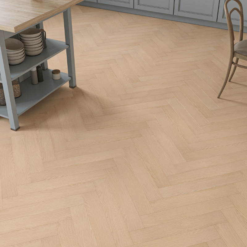 Close-up view of Prestige Herringbone 12mm Natural Oak laminate flooring in a classic herringbone design with realistic wood grain