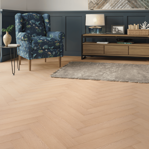 Prestige Herringbone 12mm Soft Oak laminate flooring in a spacious room with a subtle herringbone design and bevelled edges