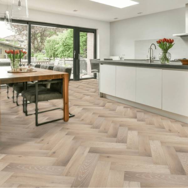 Wide room view of Buxton Herringbone Engineered Oak Flooring in Grey Brushed UV Lacquered with White Wash, enhancing a spacious interior with its timeless herringbone design