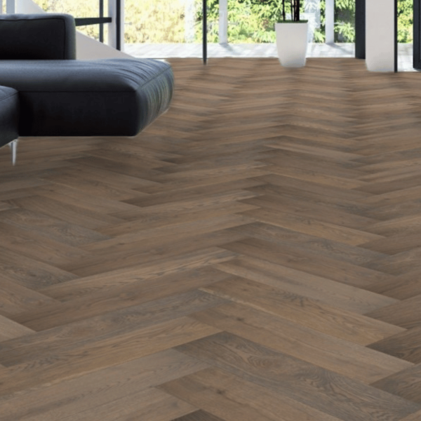 Close-up view of Castleton Herringbone Engineered Oak Flooring in Brushed Grey Stain UV Lacquered, showing the intricate wood grain and smooth bevelled edges