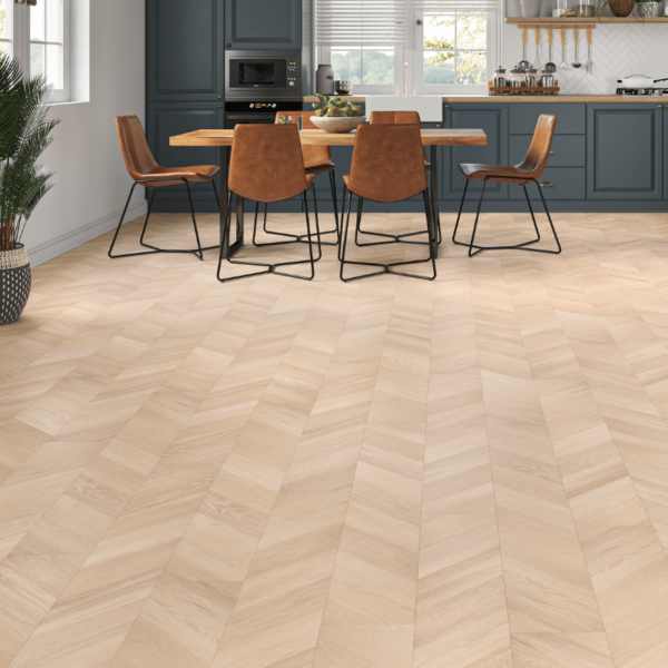 Wide room view of Madrid Chevron Laminate Light Oak flooring with warm tones and a chevron pattern