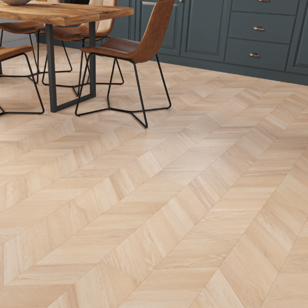 Close-up view of Madrid Chevron Laminate Light Oak plank with warm natural wood grain and bevelled edges