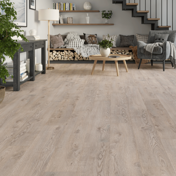 Spacious modern living area featuring Heritage Deluxe Laminate Beige Oak 12mm flooring with a soft, neutral woodgrain finish