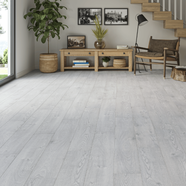 Contemporary living space featuring Heritage Deluxe Laminate Cool Oak 12mm flooring with subtle grey-toned woodgrain