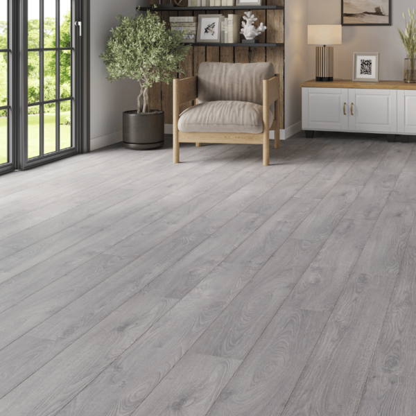 Contemporary living space featuring Heritage Deluxe Laminate Grey Oak 12mm flooring with a stylish, modern woodgrain finish