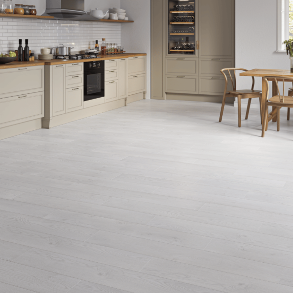 Modern living space featuring Heritage Deluxe Laminate Silver Oak 12mm flooring with sleek, silver-grey woodgrain tones