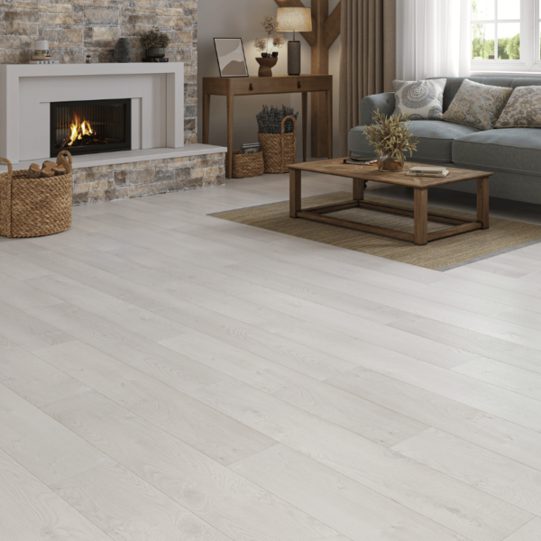 Bright and airy living space featuring Heritage Deluxe Laminate White Oak 12mm flooring with a soft, natural woodgrain finish.