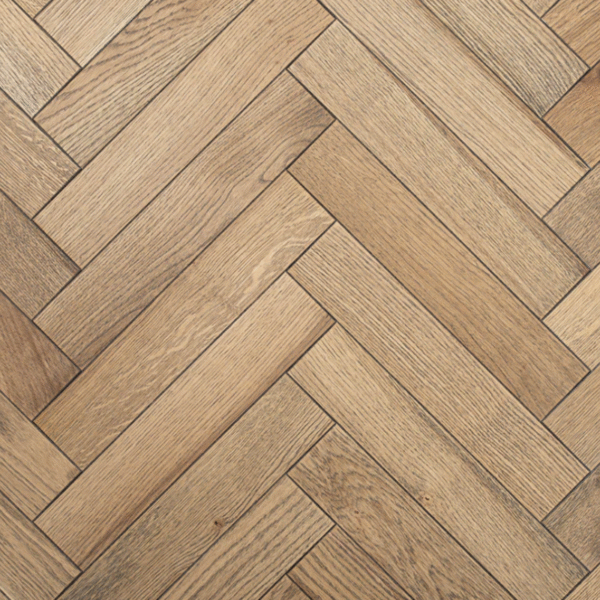 Close-up of Althorp Engineered Herringbone Oak flooring showing smoked oak tones, brushed grain, and bevelled edges.